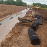 New pipeline construction at the side of a water road